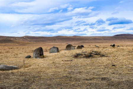 Khakassia, Siberia, Russia steppe landscape with stones in the foreground.