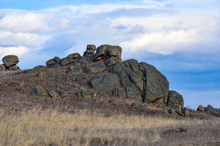 Rock in the steppe on a background of blue sky with clouds. Khakassia, Siberia, Russiaの写真素材
