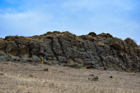Rocky hills of the Khakassia, Siberia, Russia peninsula against the background of the blue skyの写真素材