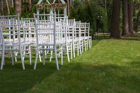 Classic white wedding chairs on a green lawn, without decoration-2 Summer.の写真素材