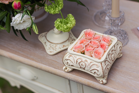Pink roses in a ceramic box on the table, beautiful flowersの写真素材