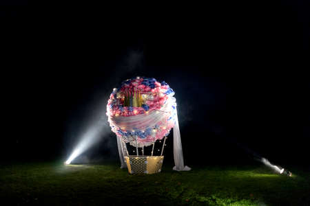 Fake ball standing on field, made of paper flowersの写真素材