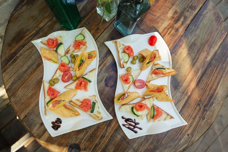 Beautifully decorated catering banquet table, two dishes on a wooden table.の写真素材