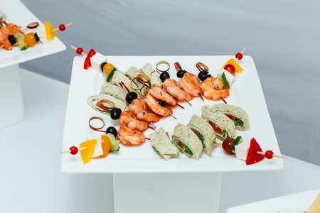 Tiger prawns on a skewer with olives. Catering.の写真素材