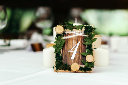 The decor at the wedding. Beautifully decorated table, with the decor. The sign in rustic style, plates and cups.の写真素材