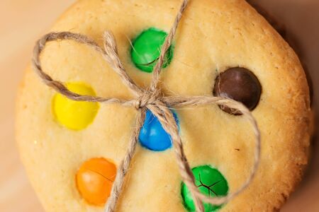 Christmas cookies with colored candies tied string. Top view, close-up.の写真素材