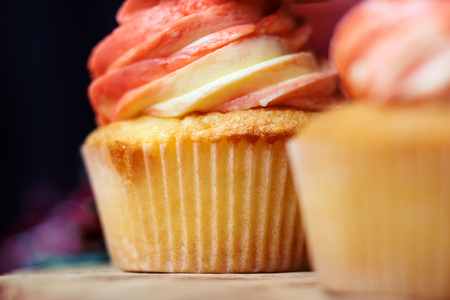 Cupcakes with pink cream cheese from the side close up.の写真素材