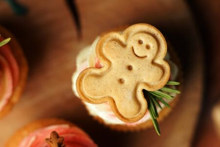 Cookies little man cupcake. Decorated with rosemary and cheese cream.の写真素材