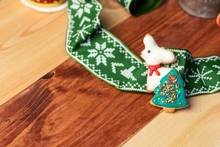 Christmas gingerbreads on a wooden background with beautiful ribbon.の写真素材