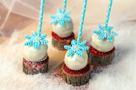 Lollypops side view on the snow. Decorated with sugar snowflakes. Close-up.の写真素材