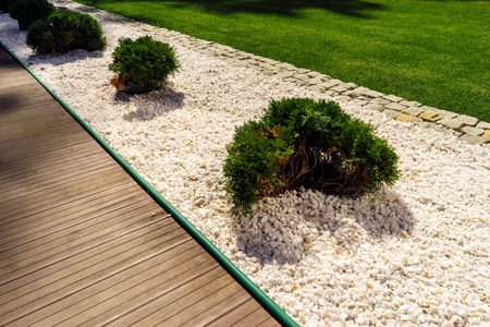 Beautiful flowerbed separates the lawn area and the pedestrian path.の写真素材