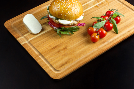 Hamburger with cheese on a bamboo dash.の写真素材