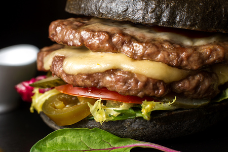 Black double hamburger made from beef, with jalapeno pepper. Big close up.の写真素材