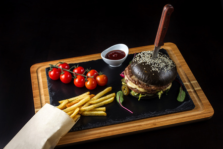 Black double hamburger made from beef with jalapeno pepper, cheese and vegetables-5の写真素材