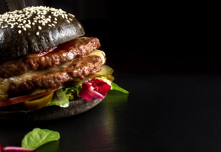Black double hamburger made from beef, with jalapeno pepper. Big close up.の写真素材