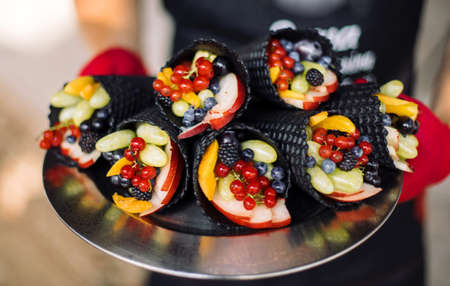 Black waffle cone with berries.の写真素材