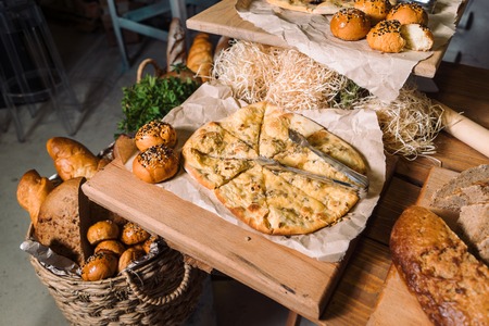 Wooden table with different types of bread.の写真素材