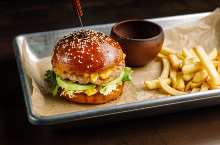 Hamburger with tavern. Lies on aluminum cuvettes.の写真素材