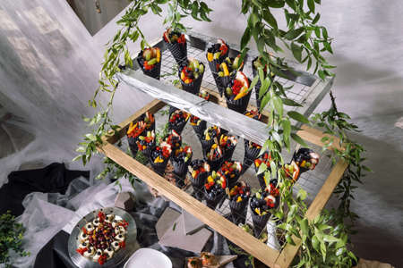 Black waffle cone with berries. Beautiful design.の写真素材