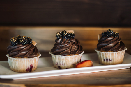 Chocolate capkake with cream and berries.の写真素材