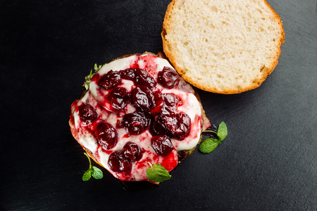 Burger, hamburger sandwich with cutlet of minced meat, cheese brie, camembert, berry cherry.の写真素材