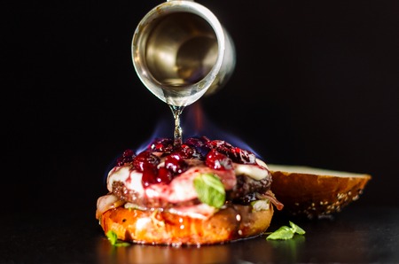 Burning burger is poured with spirits.の写真素材