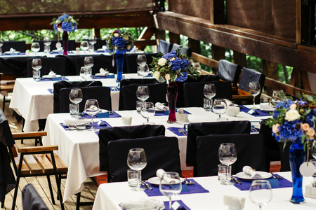 Flower arrangement on wedding table. Floral compositions with fresh roses and blue flowers-2