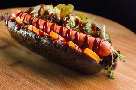 Although the dog in a black bun, with pickled cucumbers.の写真素材