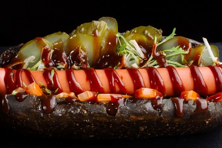 Although the dog in a black bun, with pickled cucumbers.の写真素材