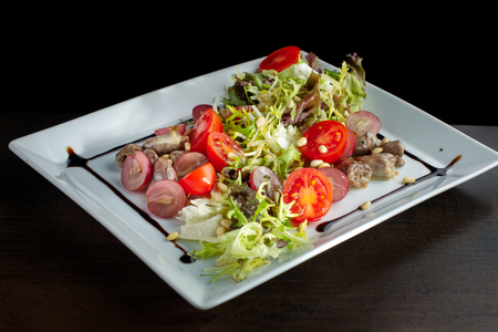 Chicken hearts, vegetable salad. Sprinkled with pine nuts.の写真素材