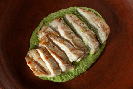 Marinated grilled chicken breasts cooked. On a clay plate.の写真素材