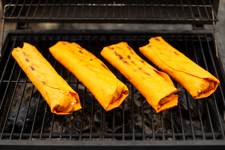 Meat on grill for shawarma. Yellow pita bread.の写真素材