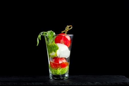 Canapes of tomatoes and cheese in a glass.の写真素材