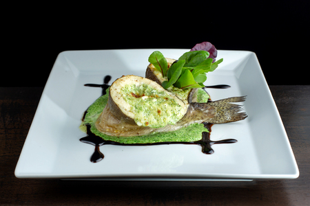 Baked fish with cheese filling. Curled circle.の写真素材