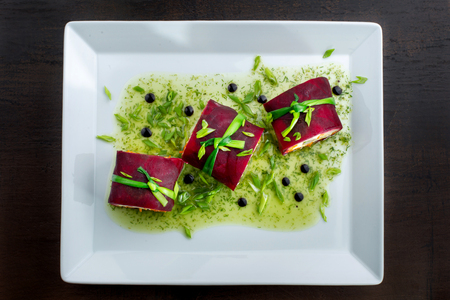 Salad with herring, beets, carrots, onions, potatoes and eggs on a plate.の写真素材