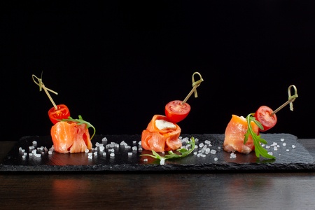 Finger food. Rolls of salmon with cream cheese.の写真素材
