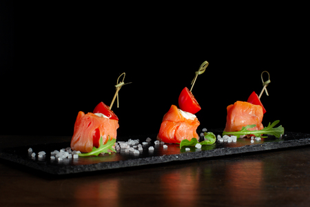 Finger food. Rolls of salmon with cream cheese.の写真素材