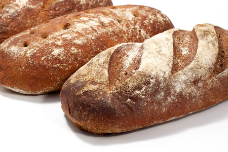 Bread - raye sourdough bread, several loaves nearby. Diagonal composition.の写真素材