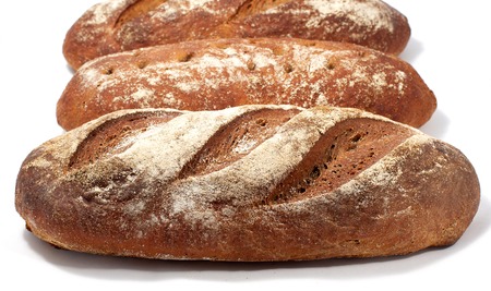 Bread - raye sourdough bread, several loaves nearby.の写真素材