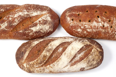 Bread sourdough bread, several loaves nearby.の写真素材