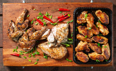 Grilled chicken wings laid out in a cast-iron tray. Tasty, beautiful and appetizing.の写真素材
