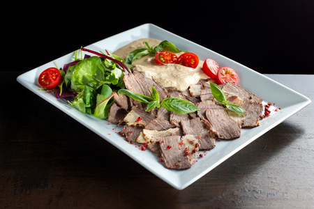 Meat cut with horseradish on a white plate.の写真素材