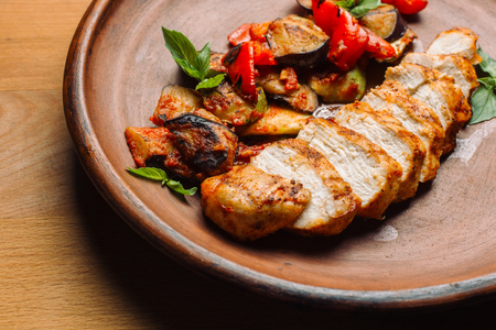Chicken breast with grilled eggplants and peppers.の写真素材