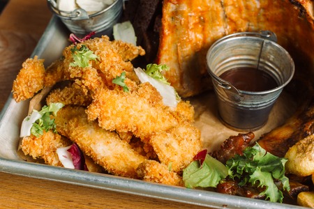 Snack to beer. Beer tray with a mountain of food.の写真素材