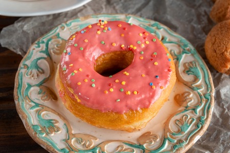 Pink donut lying on a designer plate.の写真素材