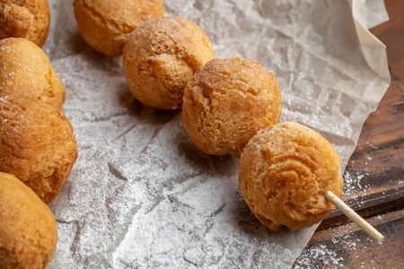 Cottage cheese balls on wooden skewers, lie on craft paper.の写真素材