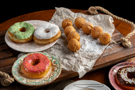 Cottage cheese balls and donutts on wooden skewers, lie on craft paper.の写真素材