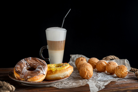 Fresh Homemade Donuts and Coffee against a background.の写真素材