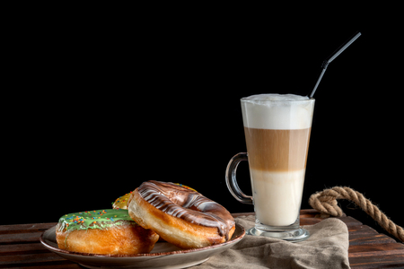 Fresh Homemade Donuts and Coffee against a background.の写真素材