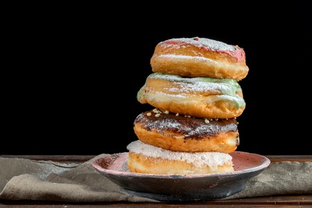 A stack of two donuts on black background.の写真素材